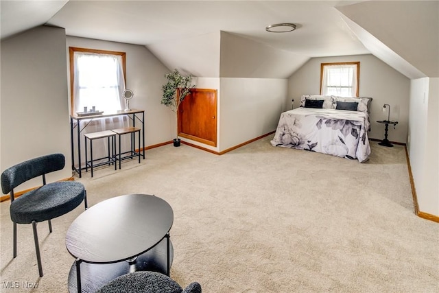 bedroom with vaulted ceiling, carpet, and baseboards