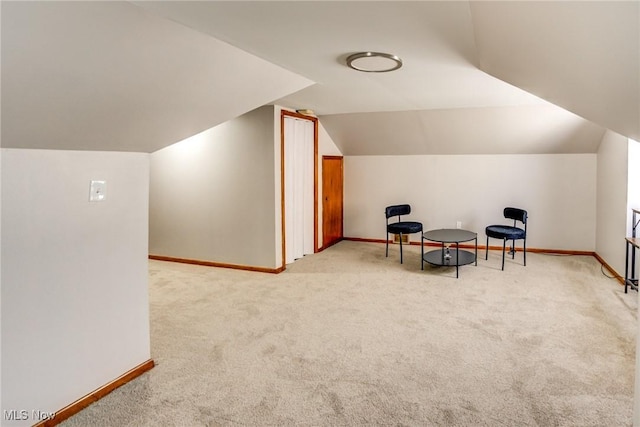 bonus room featuring baseboards, lofted ceiling, and carpet flooring