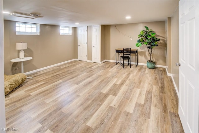 below grade area featuring baseboards and wood finished floors