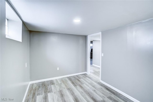 unfurnished room featuring light wood-type flooring and baseboards