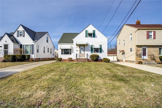 view of front of house with concrete driveway and a front lawn