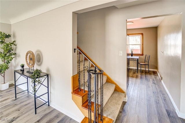 stairs featuring baseboards and wood finished floors