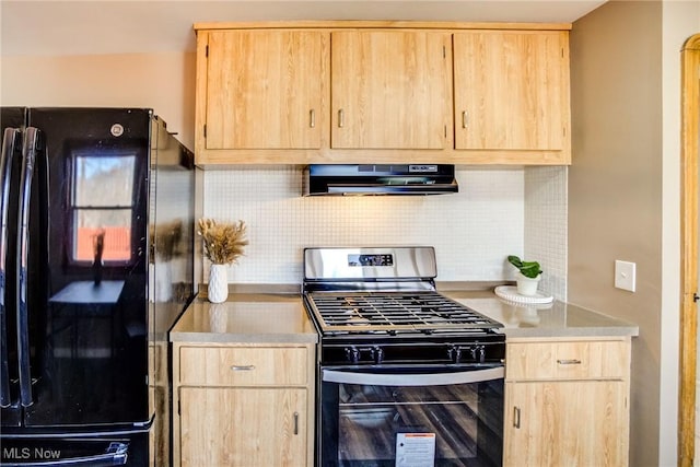 kitchen featuring backsplash, stainless steel range with gas cooktop, extractor fan, light brown cabinetry, and freestanding refrigerator