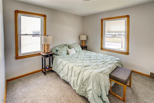 carpeted bedroom with baseboards