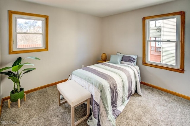 bedroom featuring multiple windows, carpet flooring, and baseboards