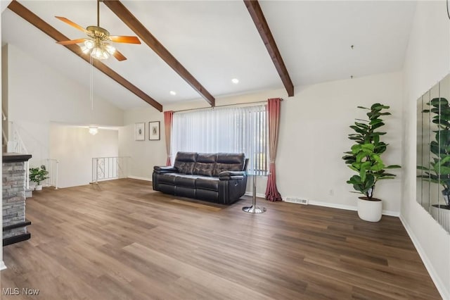 living area with beamed ceiling, wood finished floors, baseboards, and high vaulted ceiling