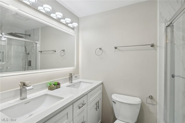 bathroom featuring a sink, toilet, double vanity, and a shower stall