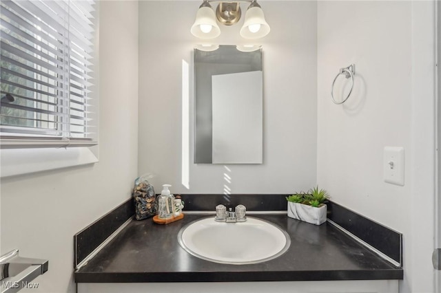 bathroom featuring a chandelier and vanity