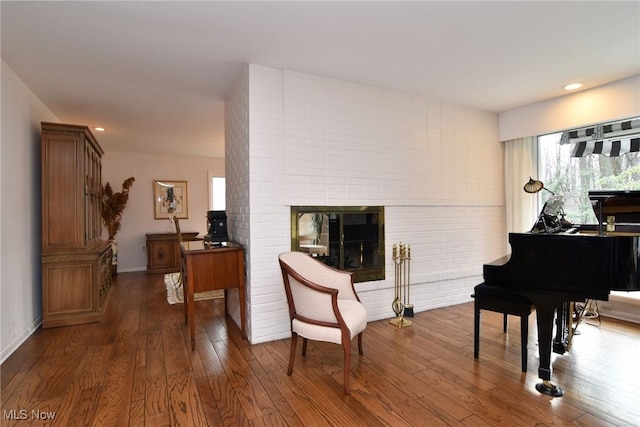 living area featuring dark wood finished floors, recessed lighting, a fireplace, and baseboards