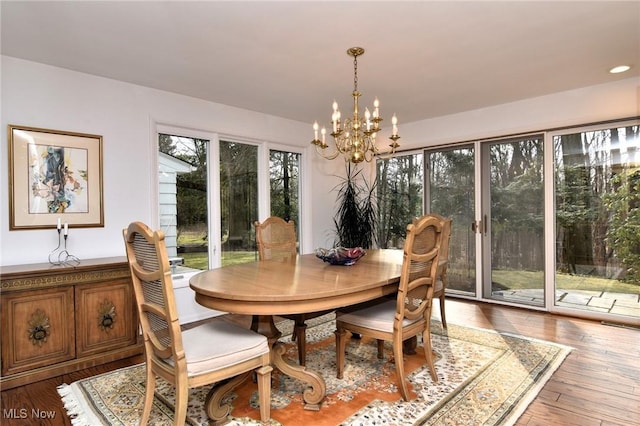 dining area featuring an inviting chandelier and hardwood / wood-style flooring