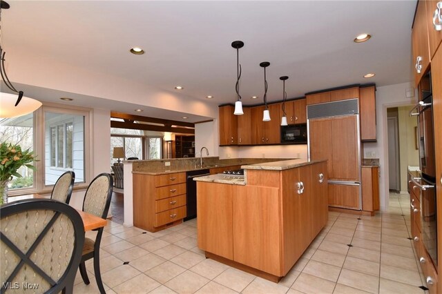 kitchen with a kitchen island, a peninsula, recessed lighting, a sink, and black appliances