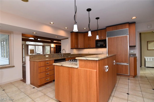 kitchen with light tile patterned flooring, brown cabinets, built in appliances, and a center island