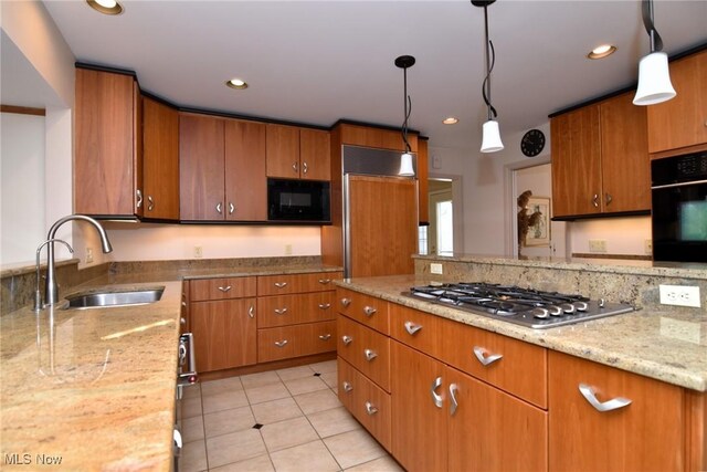 kitchen with black appliances, recessed lighting, brown cabinets, and a sink