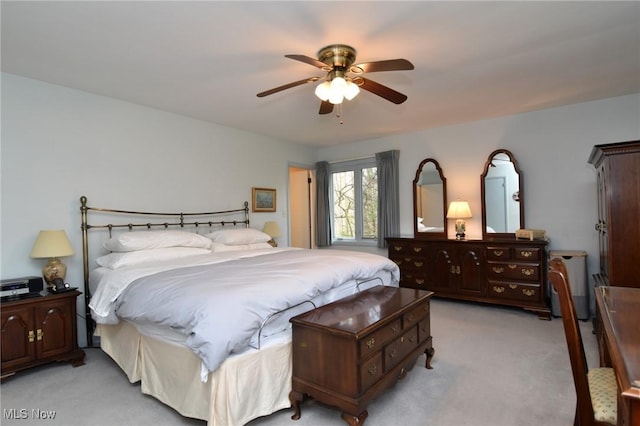 bedroom featuring a ceiling fan and light carpet