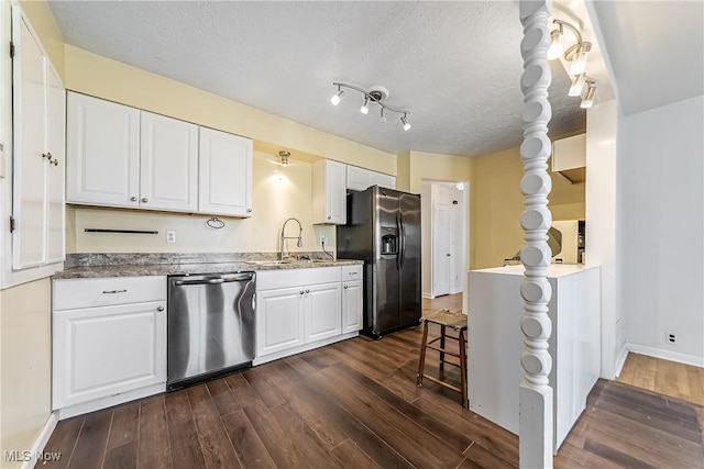 kitchen featuring dark wood-style floors, black fridge with ice dispenser, dishwasher, and a sink