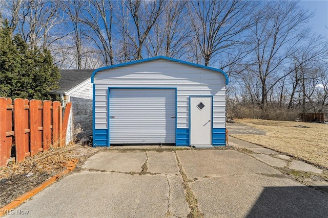 detached garage with driveway and fence