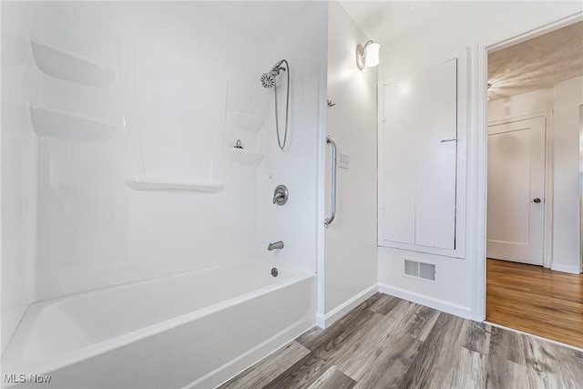 full bath with visible vents, baseboards, wood finished floors, and  shower combination