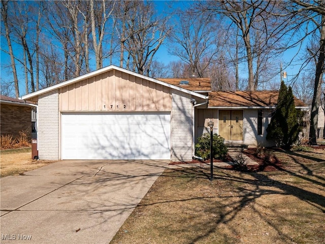 view of front facade with brick siding, driveway, and a garage