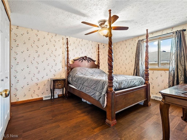 bedroom featuring baseboards, wood finished floors, and wallpapered walls