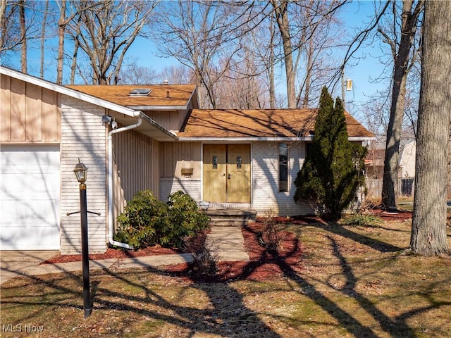 entrance to property with board and batten siding, a garage, and brick siding