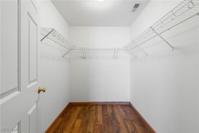 walk in closet featuring wood finished floors and visible vents