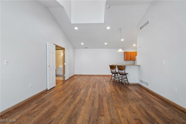 unfurnished living room featuring recessed lighting, visible vents, baseboards, and dark wood-type flooring