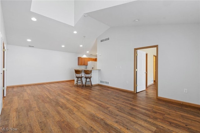 interior space featuring visible vents, baseboards, and wood finished floors