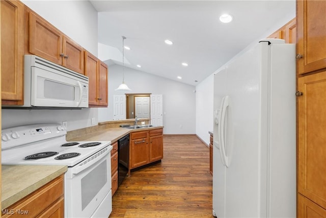 kitchen with dark wood-type flooring, a sink, white appliances, light countertops, and lofted ceiling