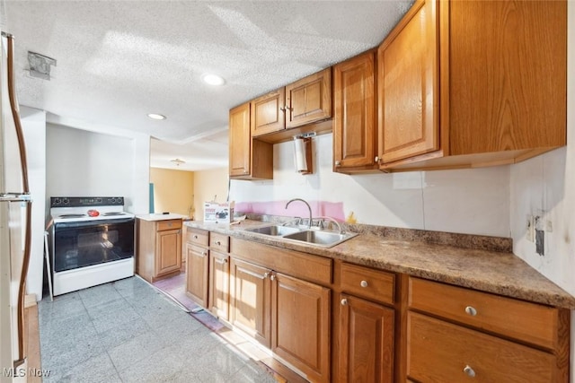 kitchen featuring light floors, brown cabinets, white range with electric stovetop, a textured ceiling, and a sink