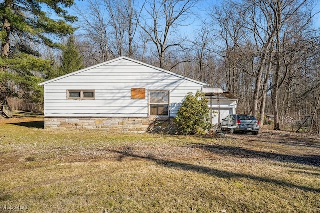 view of side of home featuring a yard and crawl space