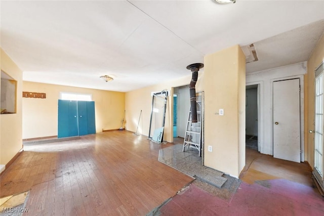 interior space with baseboards and wood-type flooring