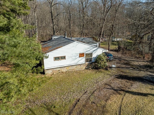 view of home's exterior featuring a forest view