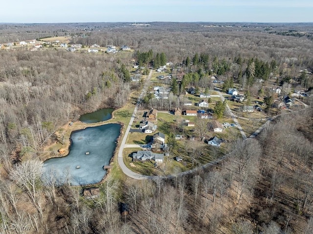 drone / aerial view with a view of trees and a water view