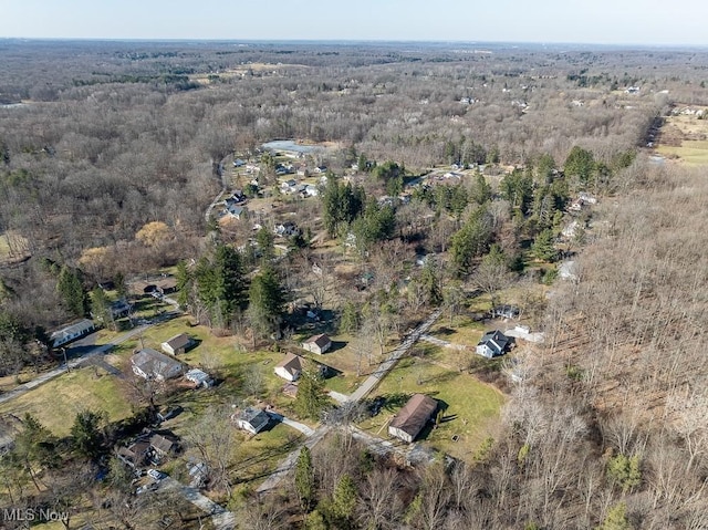 birds eye view of property with a wooded view