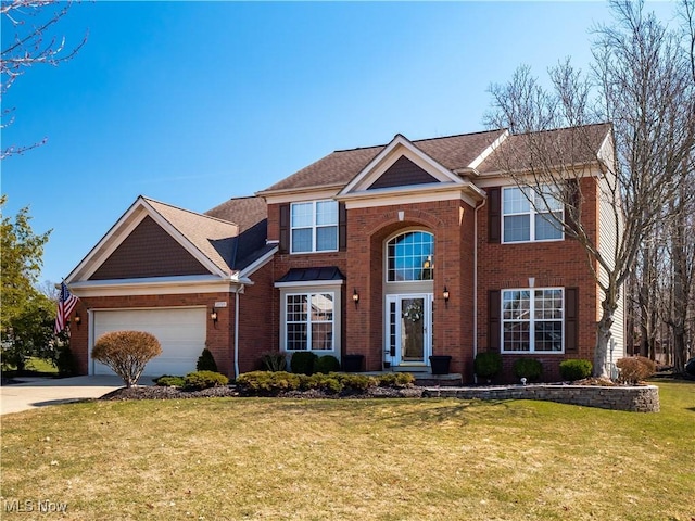 view of front of home with brick siding, an attached garage, driveway, and a front lawn