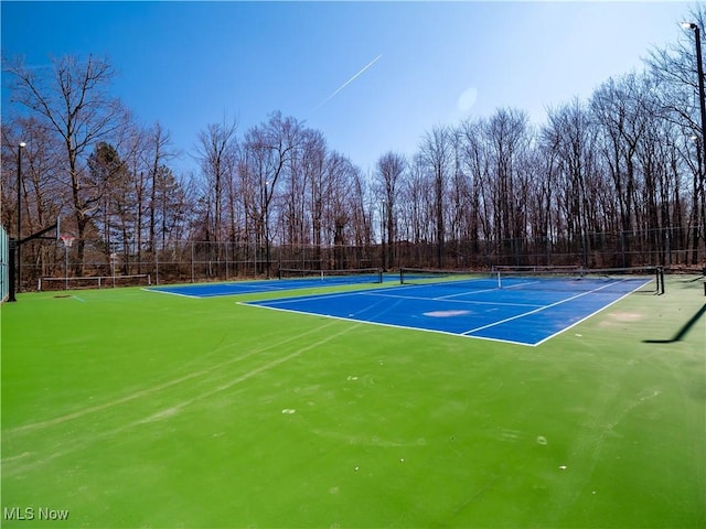 view of tennis court with fence