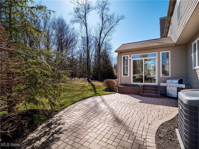 view of patio / terrace featuring area for grilling and central air condition unit