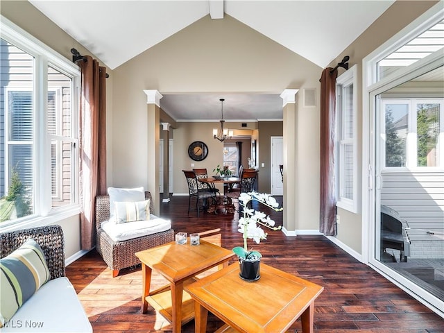 living room with wood-type flooring, an inviting chandelier, crown molding, baseboards, and vaulted ceiling with beams