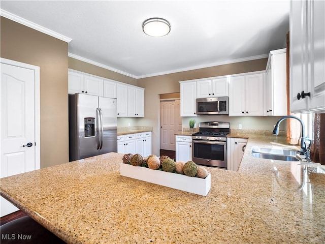 kitchen with light stone countertops, ornamental molding, appliances with stainless steel finishes, a peninsula, and a sink