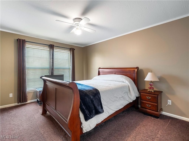 bedroom featuring baseboards, a ceiling fan, dark carpet, and crown molding