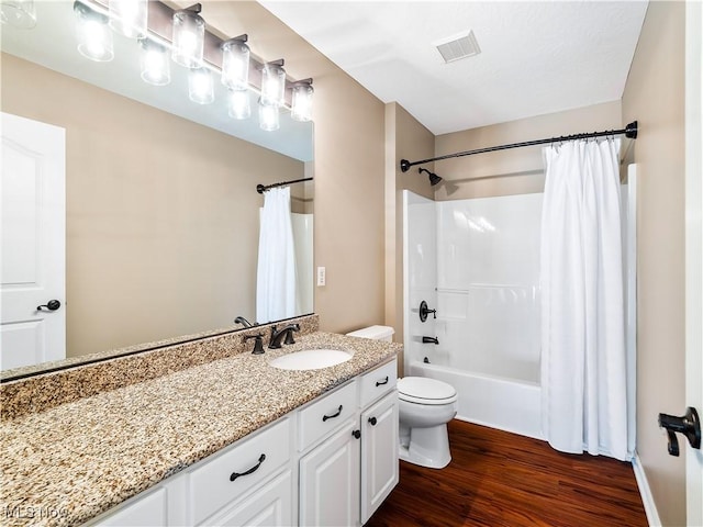 full bath with vanity, wood finished floors, visible vents, shower / bath combination with curtain, and toilet