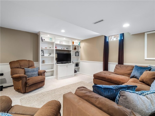 living room with recessed lighting, light colored carpet, and visible vents