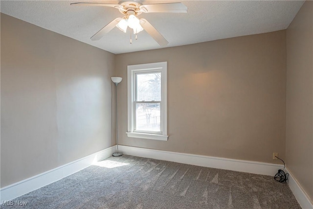 unfurnished room with a textured ceiling, carpet, baseboards, and ceiling fan