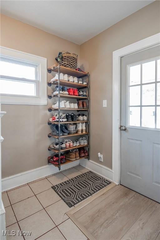 interior space with tile patterned floors and baseboards