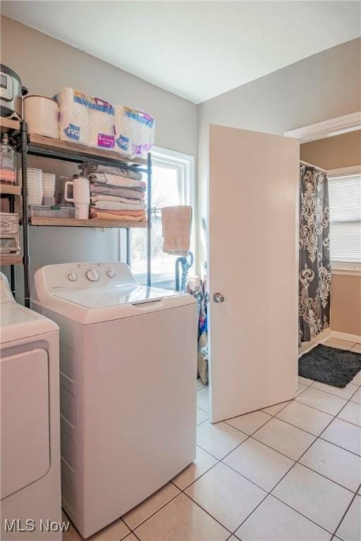 laundry area with laundry area, light tile patterned floors, and separate washer and dryer