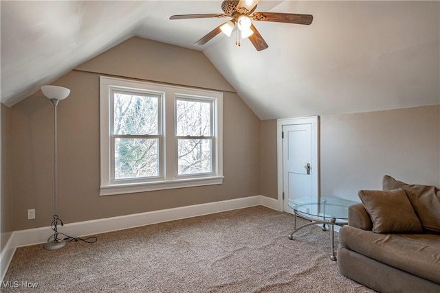 interior space with lofted ceiling, a ceiling fan, baseboards, and carpet floors