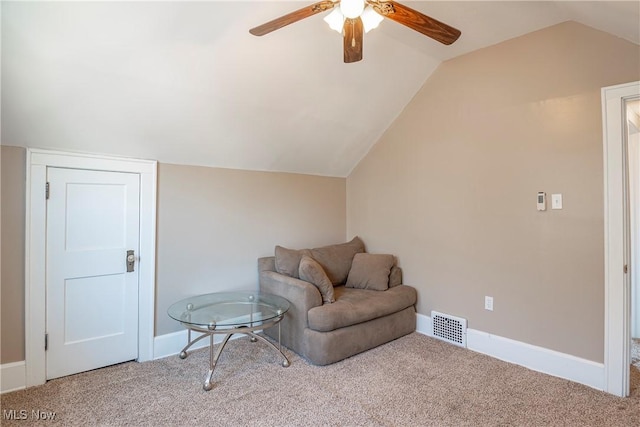 living area featuring visible vents, carpet flooring, baseboards, and vaulted ceiling