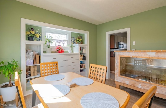 dining area with wood finished floors