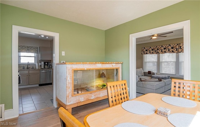 dining space with a ceiling fan and wood finished floors