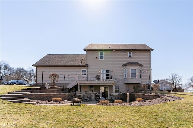 back of property with stairway, a lawn, a patio, and a deck